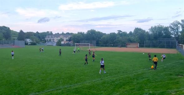 Bri Menssen (10) crossing ball to Angie Martin (13)  in front of goal and Anna Erickson (4) on the left.