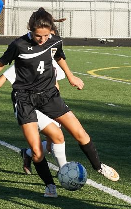 Anna Erickson at center midfield, winning a contested ball with Johnson midfielder. (Photo cr. to Michele Cohn)
